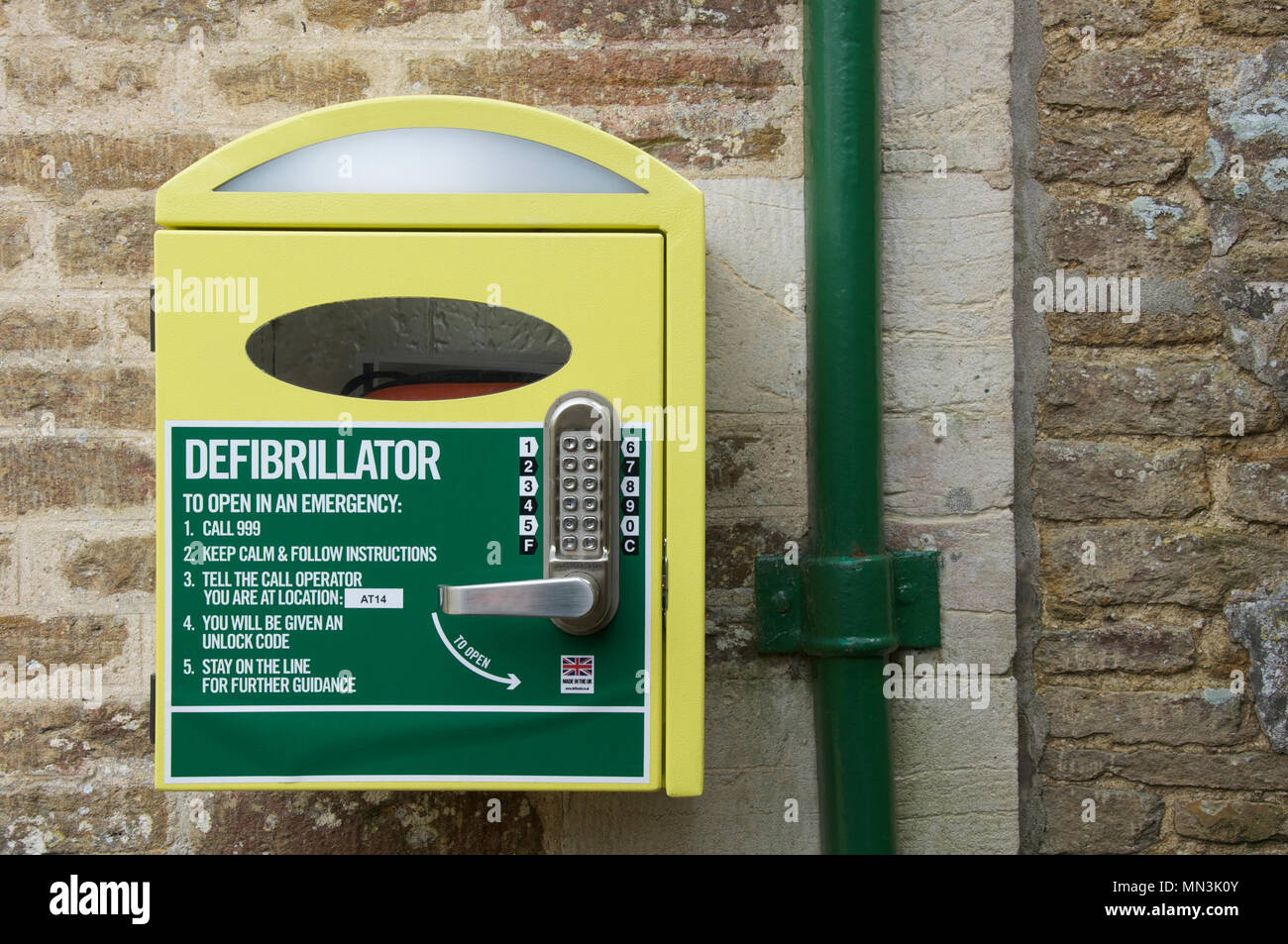 Automated external defibrillator (AED). Emergency life saving medical equipment in a wall mounted cabinet located in a rural Dorset village. England. Stock Photo