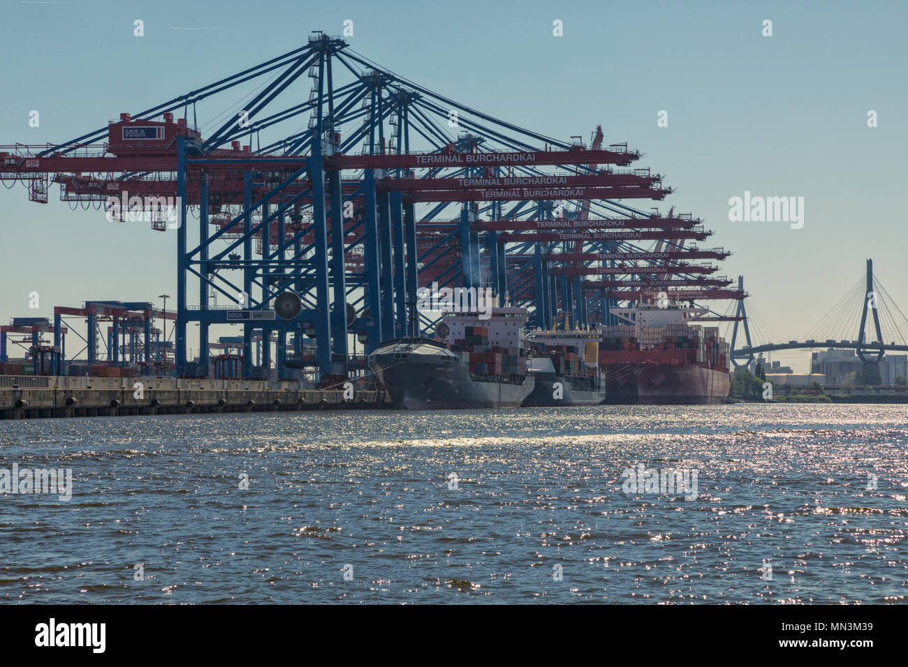 Container ships moored at Terminal Burchardkai  at the port of Hamburg. Köhlbrandbrücke bridge in background Stock Photo