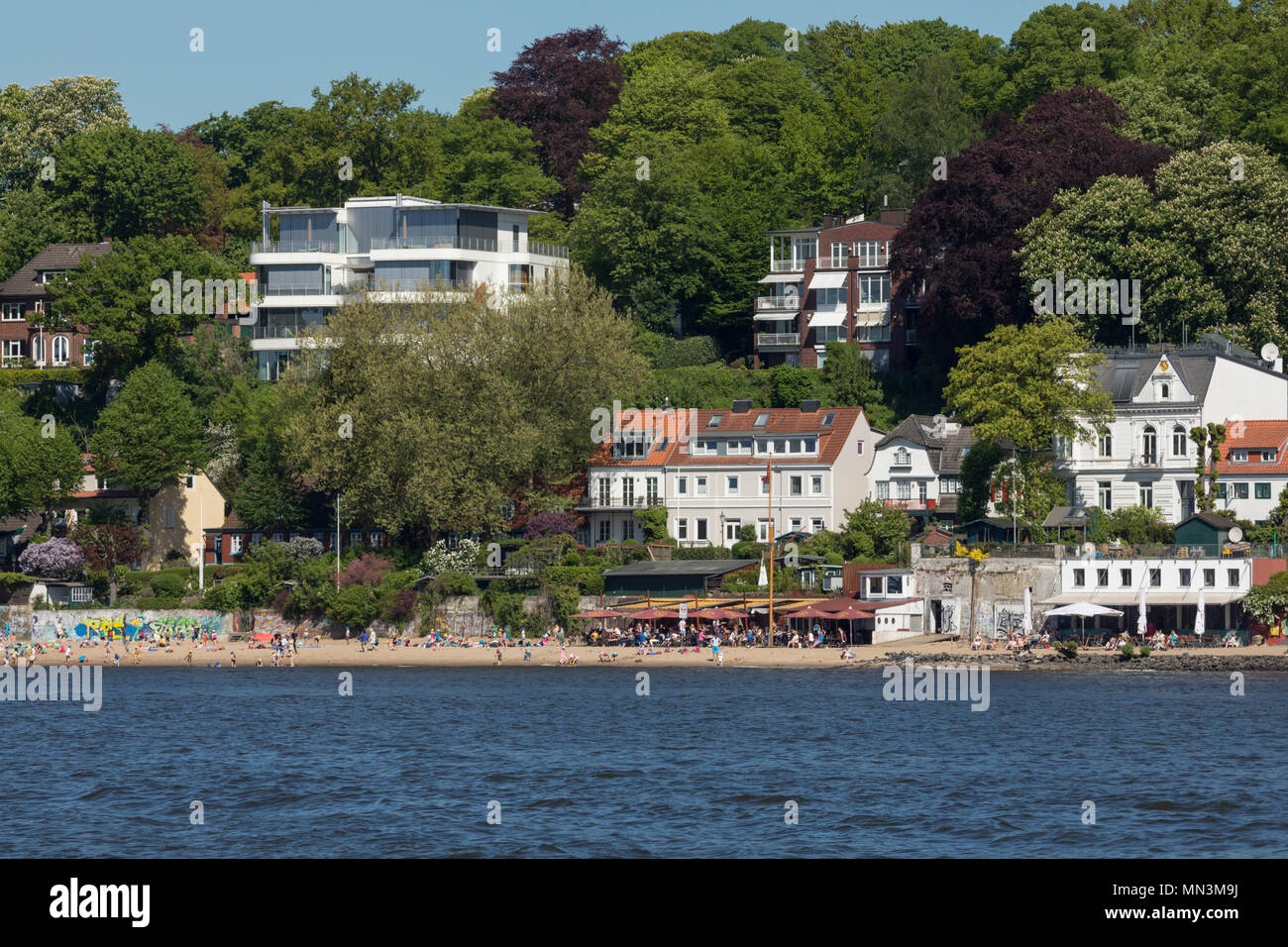 Elbe Beach with beach bars and homes on the hillside at Hamburg Stock Photo