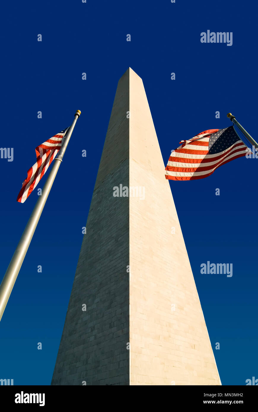 The Washington Monument  with two American flags. Located in Washington DC along the National Mall. Stock Photo