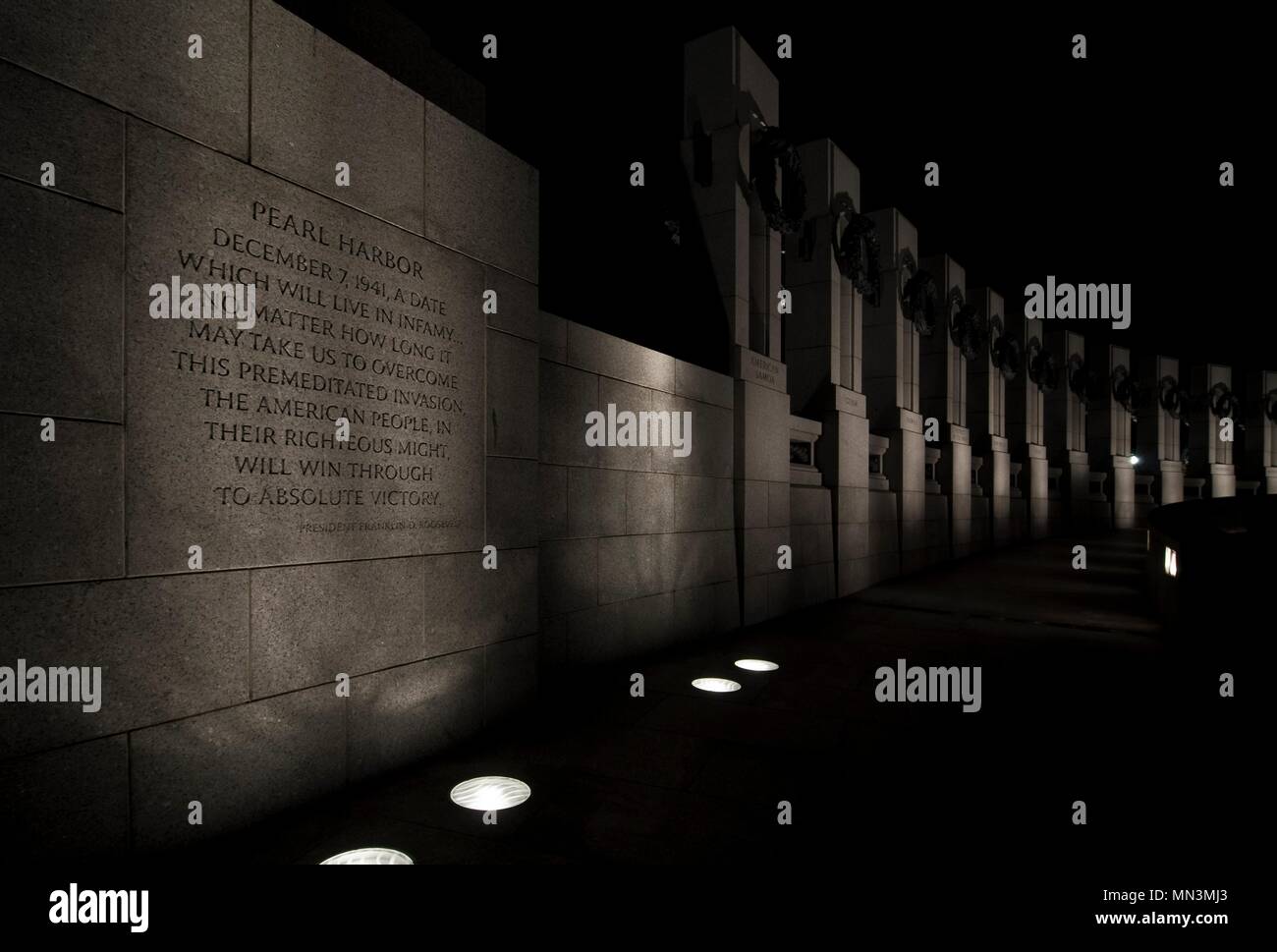 The World War II Memorial at night.  The inscription from president Franklin D. Roosevelt on the wall can be read.   Located in Washington DC. Stock Photo