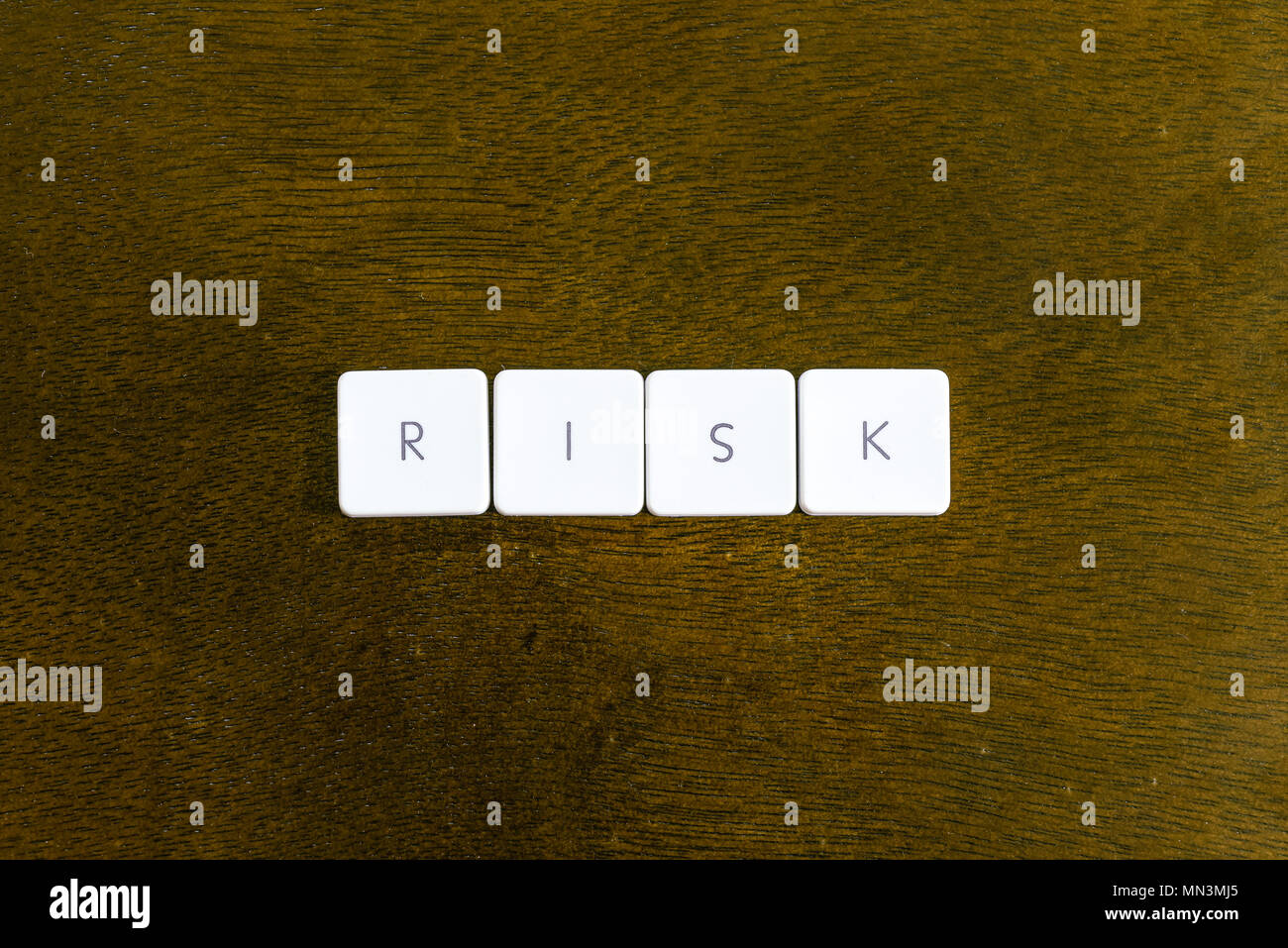 RISK word written on plastic keyboard alphabet with dark background ...