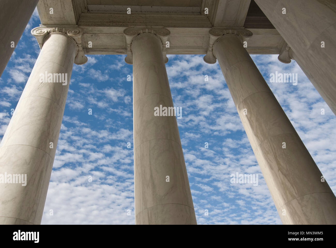 Marble  Doric columns against a beautiful blue, cloud filled sky at the Jefferson Memorial in Washington DC. Stock Photo