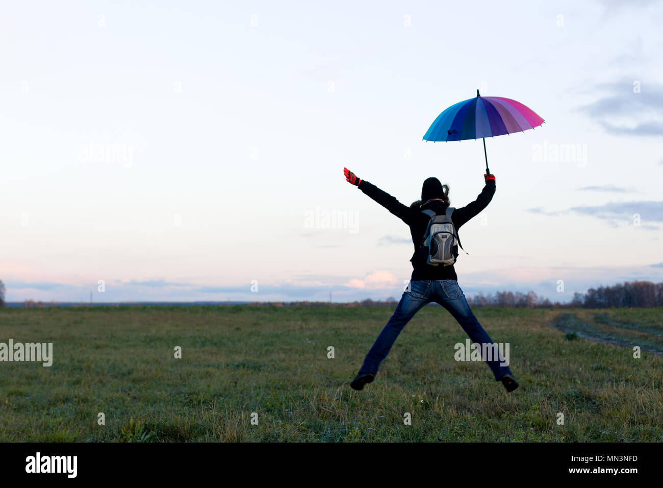 Young emotional woman with an umbrella on a walk Stock Photo