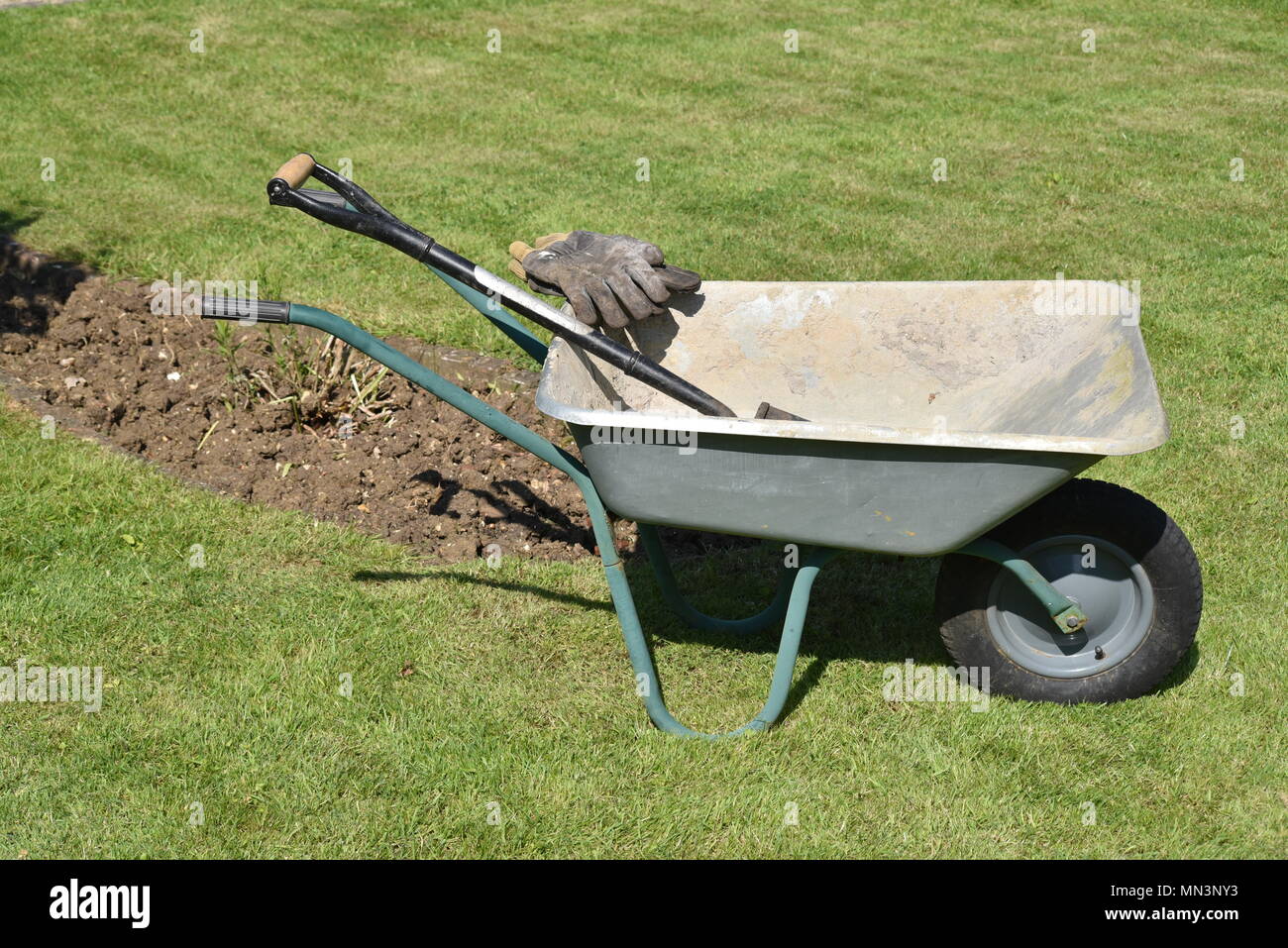 wheel barrow with gardening tools Stock Photo