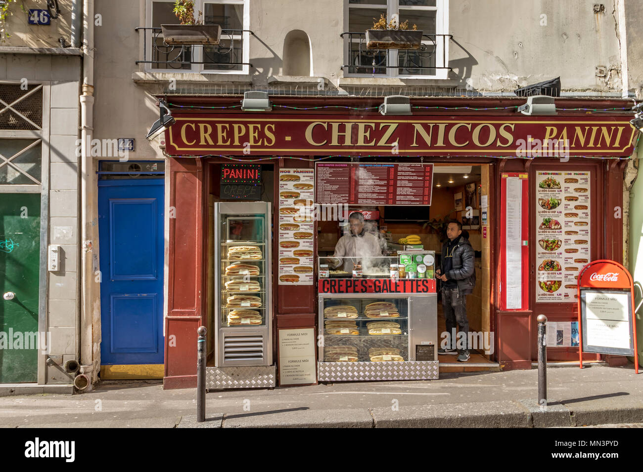 Man buying crepes at Chez Nico's Creperie ,Rue Mouffetard, Paris, France Stock Photo