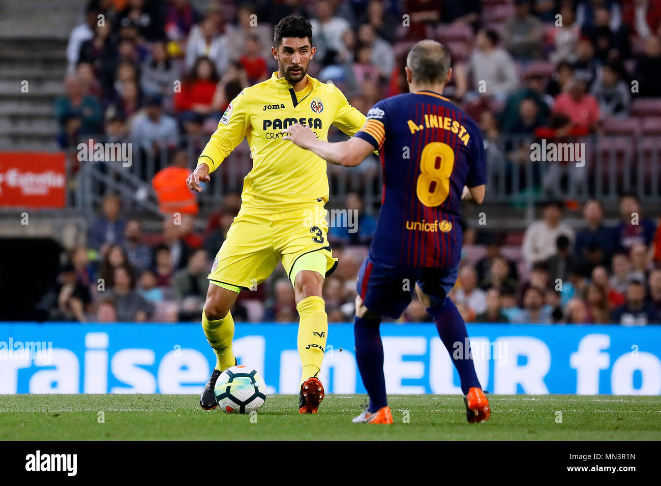 Barcelona, 9th May: Alvaro Gonzalez of Villarreal CF in action with Andres Iniesta of FC Barcelona during the 2017/2018 LaLiga Santander Round 34 game Stock Photo