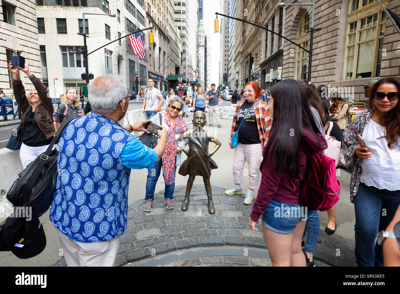 Tourists surrounding The Fearless Girl statue by Kristen Visbal, downtown New York, New York City, United States of Stock Photo