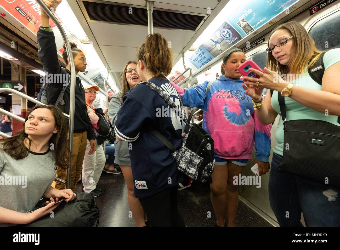 New York teenagers travelling on the New York subway, New York City, USA Stock Photo