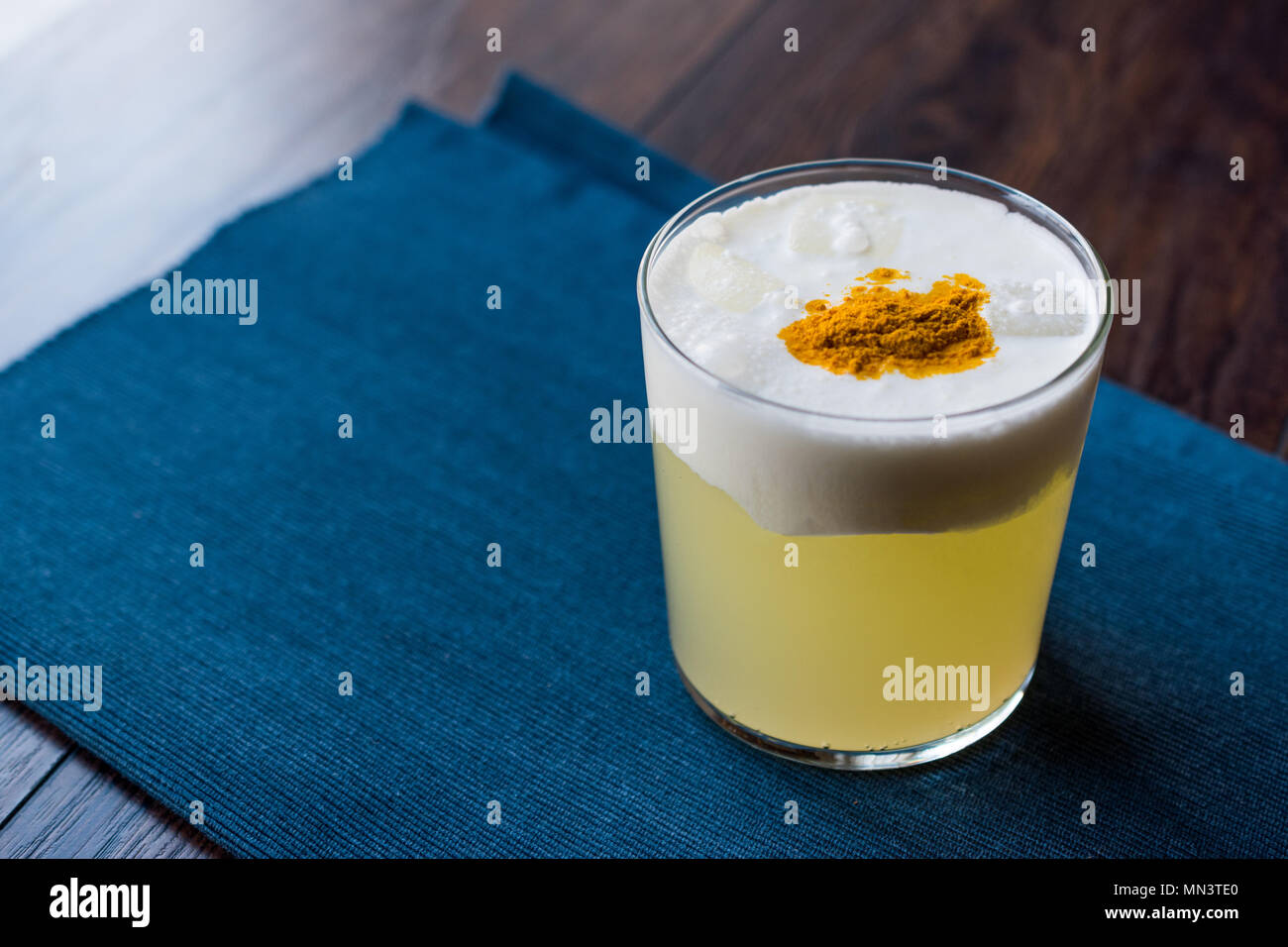Spicy Pisco Sour Cocktail made with Lime juice, Egg White and Peruvian Grape Schnaps. Beverage Concept. Stock Photo