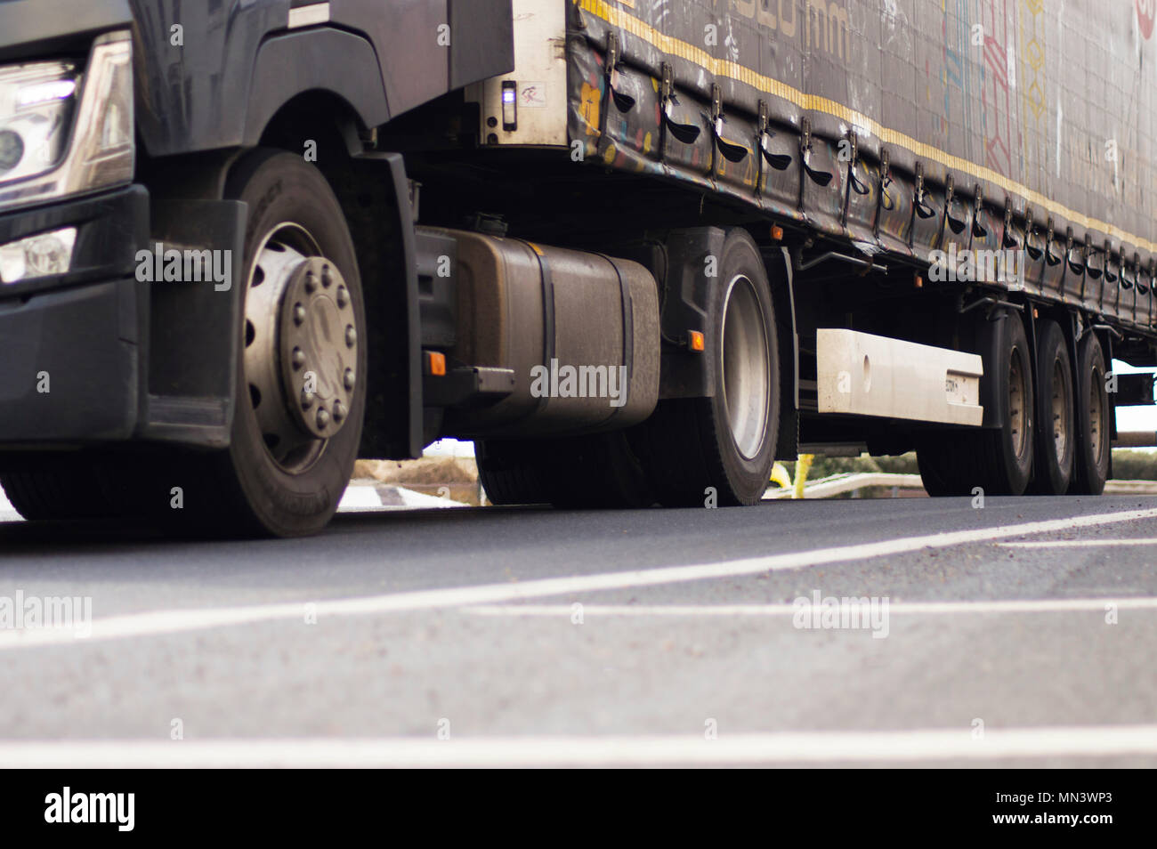 The wheels and undercarriage of a black lorry Stock Photo