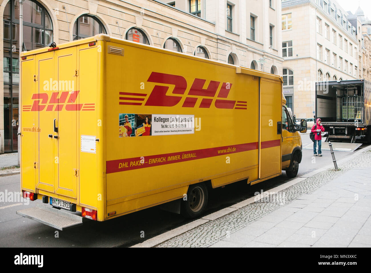 Berlin, Germany 15 February 2018: DHL and German international company or leader of the world logistic market. Courier service for mail transportation. Stock Photo