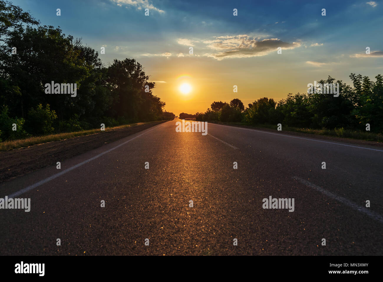 asphalt road to horizon in sunset Stock Photo - Alamy