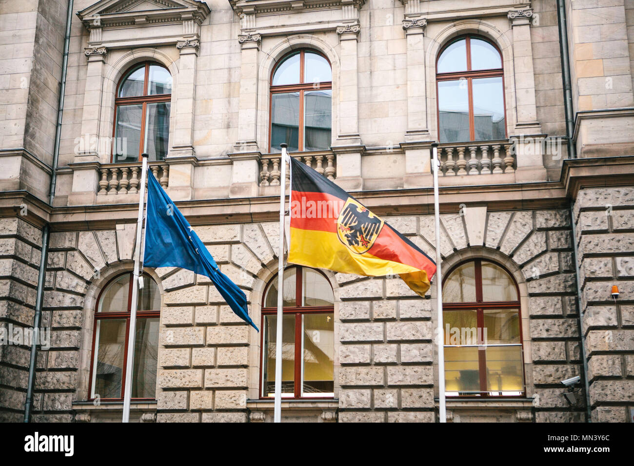 Flag of Germany and the European Union in Berlin. State symbol and national government flag of the Federal Republic of Germany and EU Stock Photo