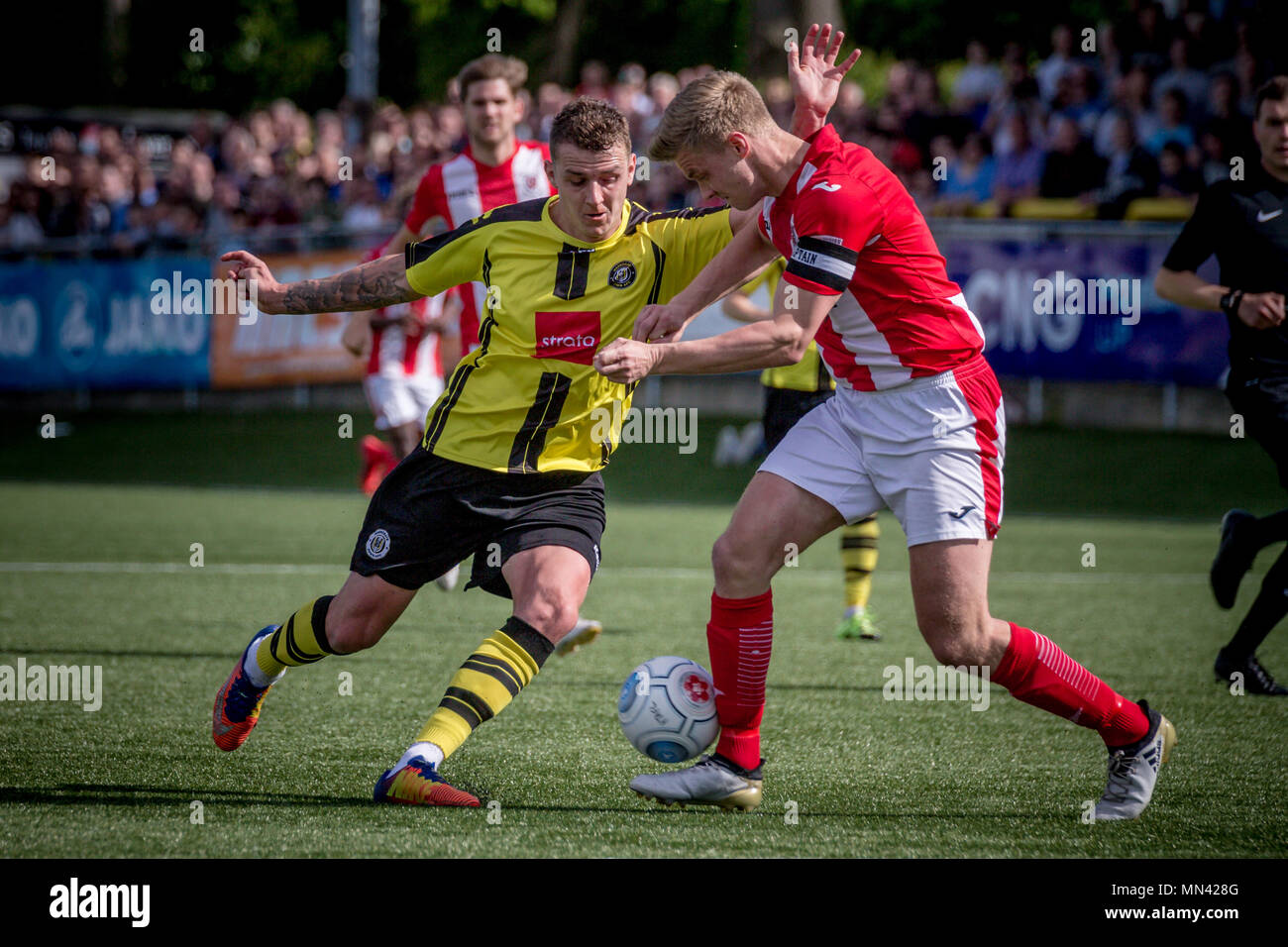 Harrogate, Yorkshire, UK. 13th May, 2018. News: Harrogate Town Promoted to the National League, The CNG Stadium, Harrogate North Yorkshire, UK. 13 May 2018.   Joe Leesley (Harrogate Town) runs at Gareth Dean (Captain) (Brackley Town) and beats him to get a shot in on goal.  Harrogate Town 3-0 Brackley Town - National League North playoff final at the CNG Stadium in Harrogate. Harrogate are promoted to the National League for the 2018/19 season. Credit: Caught Light Photography Limited/Alamy Live News Stock Photo