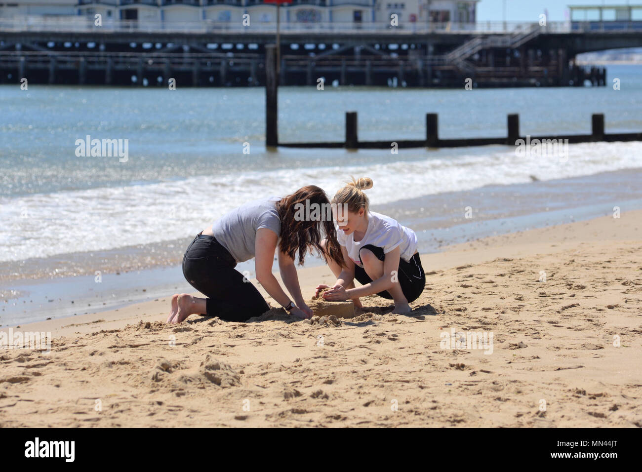 Two Teenage Girls Building A Sandcastle On A Sunny Day In Summer On The Sandy Beach At Bournemouth Dorset Uk A Popular English Resort Stock Photo Alamy