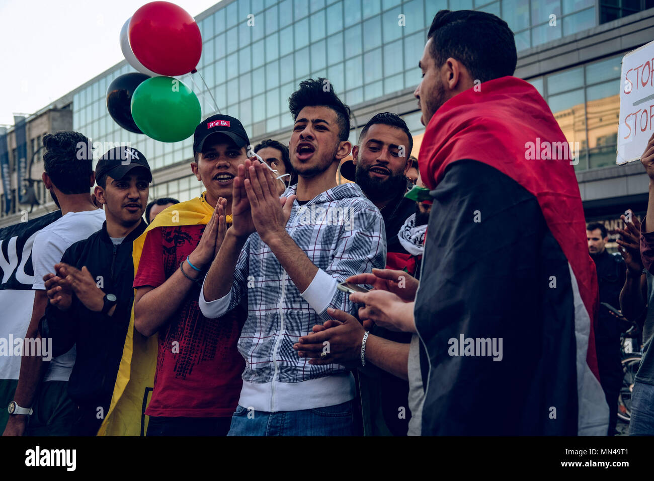 Berlin, Germany. 14th may 2018. Young men sing at the protest in Berlin against Israel actions in Gaza. Hundreds of demonstrators gathering in Berlin to protest the violent actions that has been taken by the Israeli military in Gaza which has led to at least 50 dead. Credit: SOPA Images Limited/Alamy Live News Stock Photo