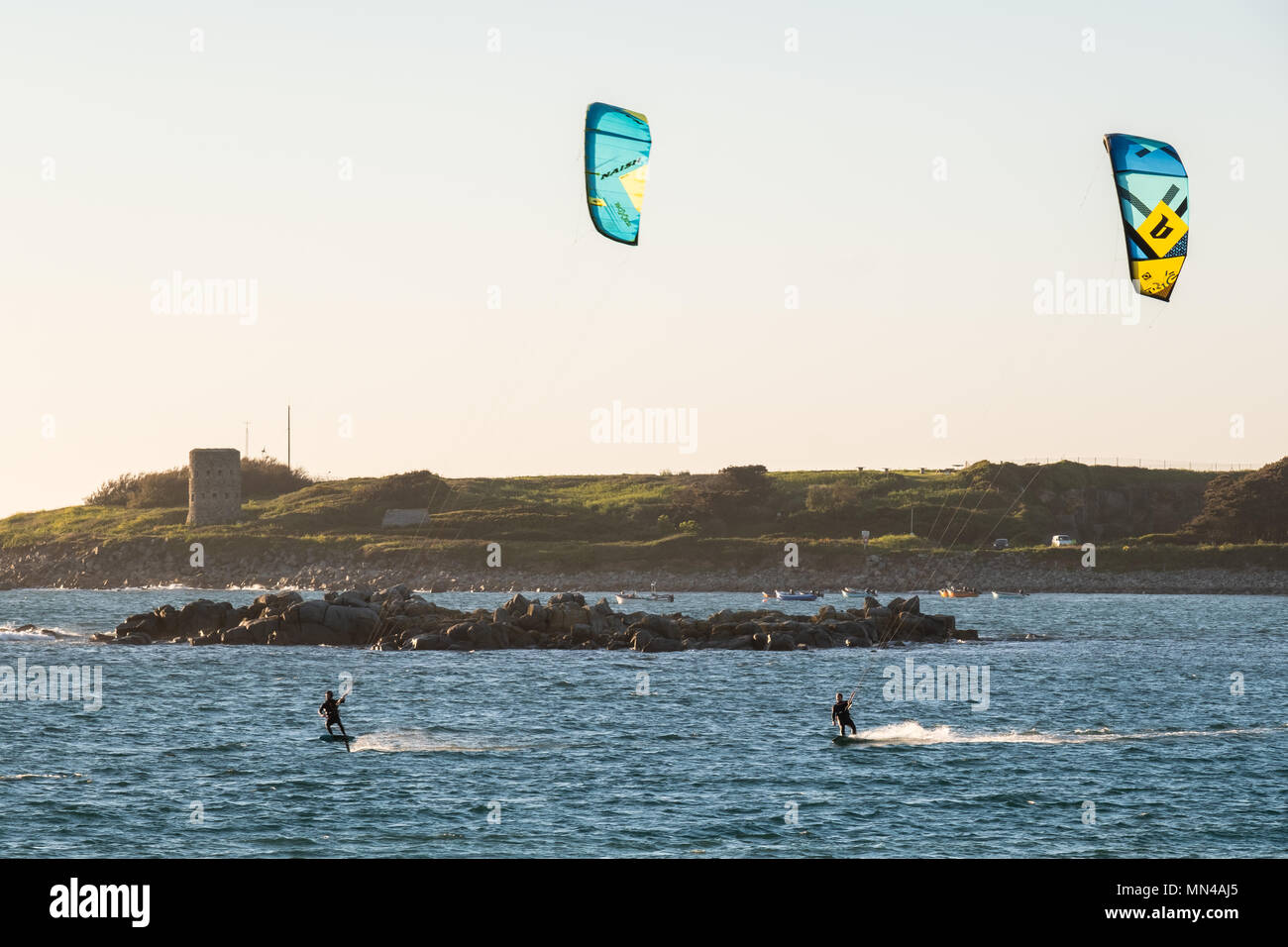Les Amarreurs, Guernsey. 14th May, 2018. People enjoying kite surfing just before sunset in Les Amarreurs on the Channel Island of Guernsey on Monday, May 14, 2018. Credit: Christopher Middleton/Alamy Live News Stock Photo