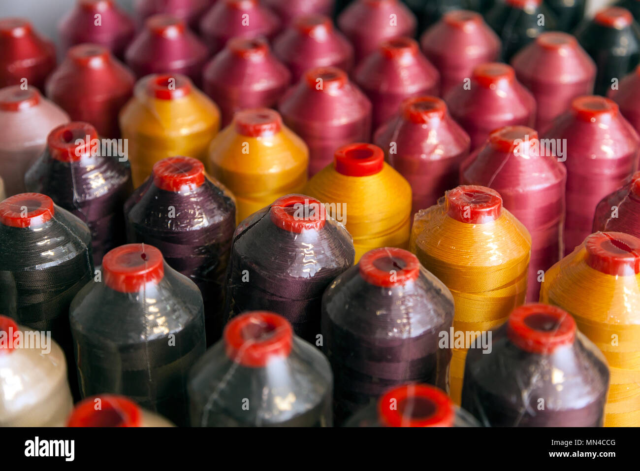 Close-up of even rows of different-colored high-quality threads of ...