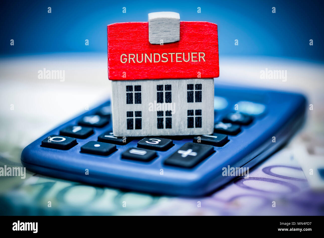 House on a calculator, land tax, Haus auf einem Taschenrechner, Grundsteuer Stock Photo