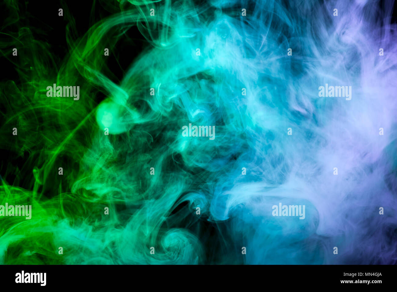 Green and blue smoke on black background Stock Photo - Alamy