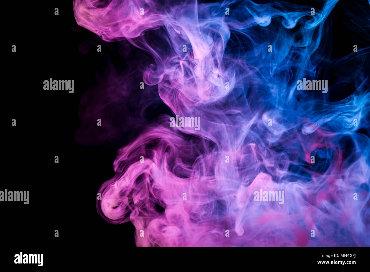 Blue and pink smoke on black background Stock Photo - Alamy