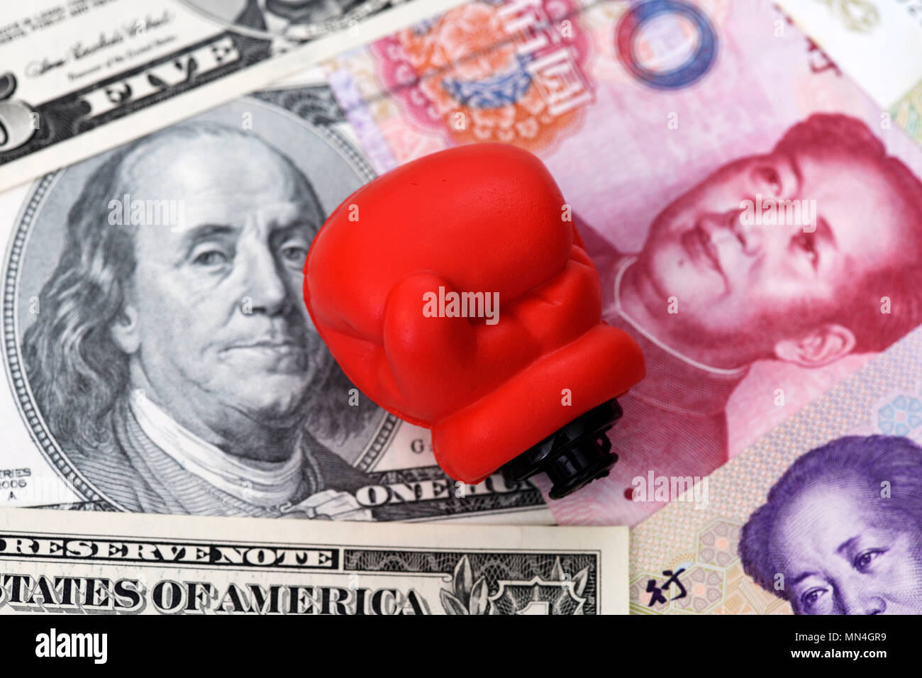 Boxing gloves on dollar bills and Chinese renminbi, impending trade war between the US and China, Boxhandschuh auf Dollarnoten und chinesischen Renmin Stock Photo