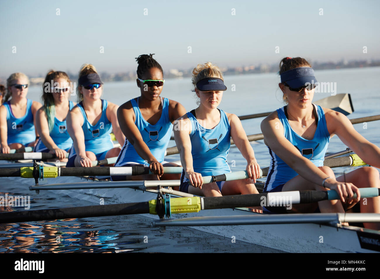 Female rowers rowing scull on sunny lake Stock Photo Alamy