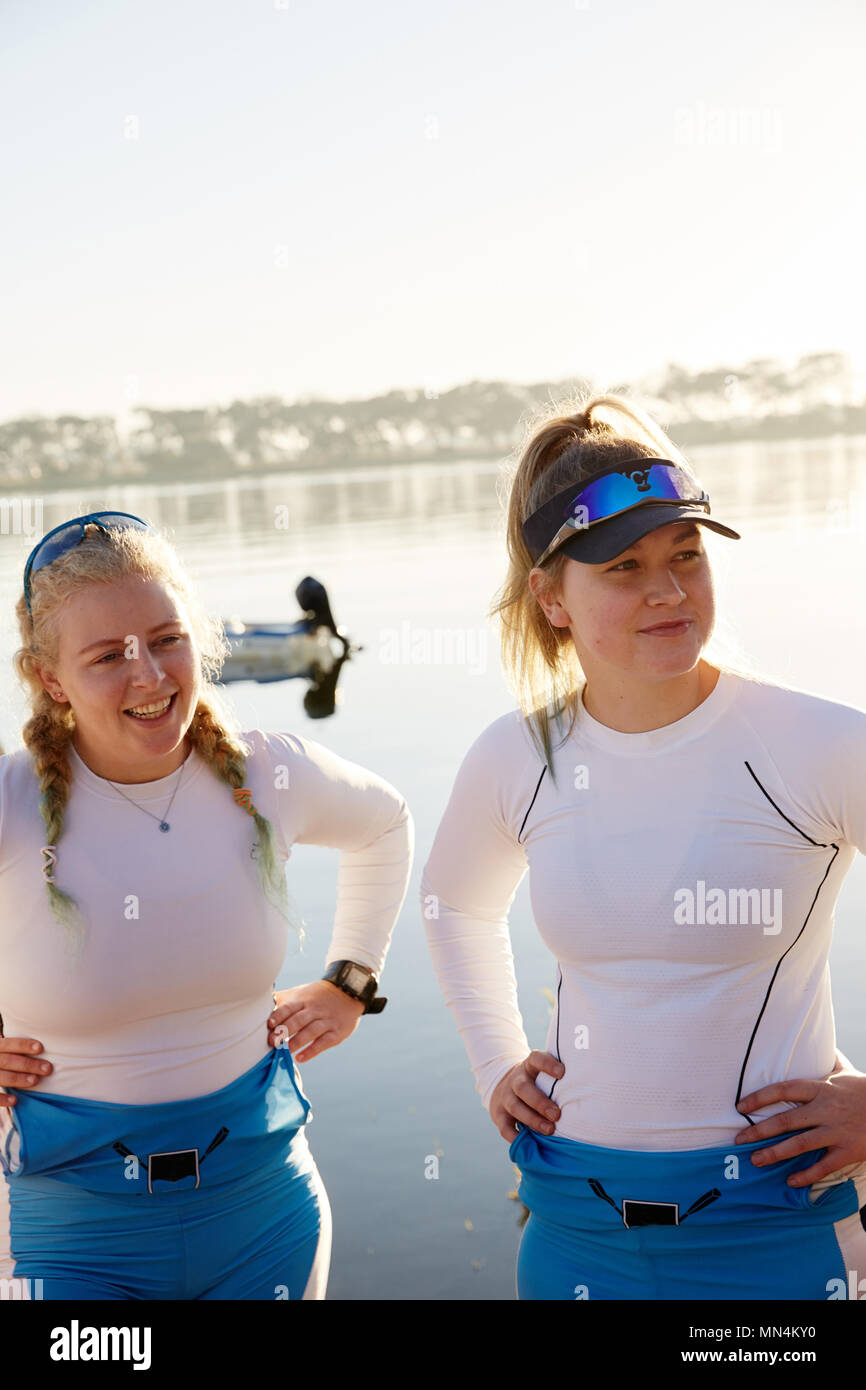 Female rowers with hands on hips at sunny lakeside Stock Photo - Alamy