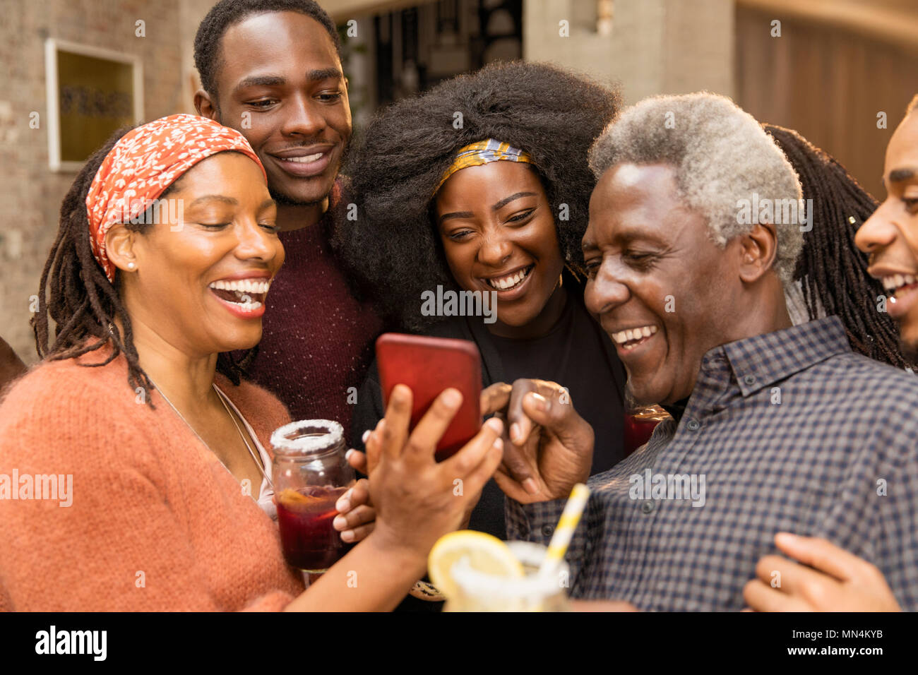 Happy multi-generation family using smart phone Stock Photo