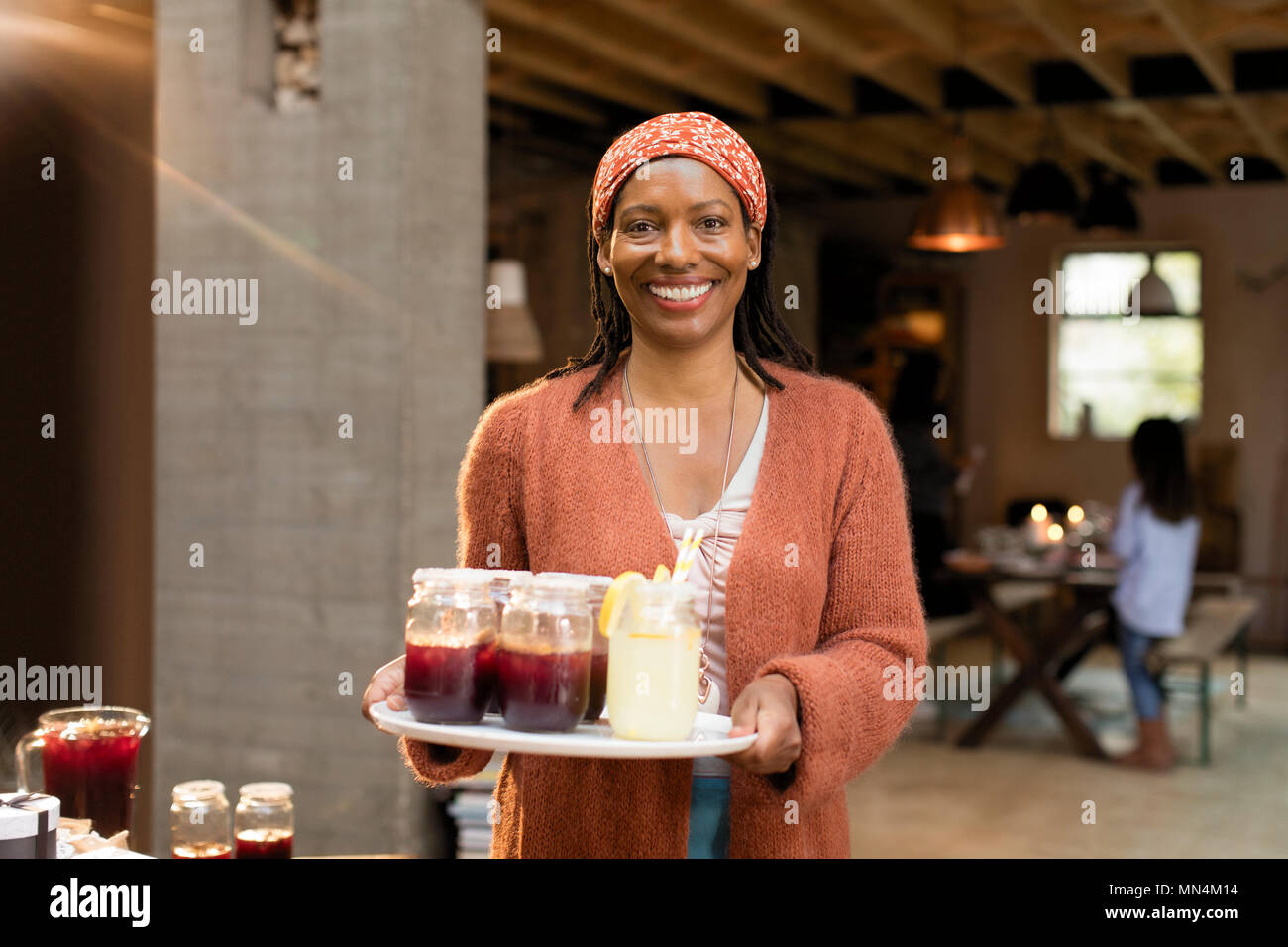 Portrait smiling, confident woman serving lemonade and sangria Stock Photo