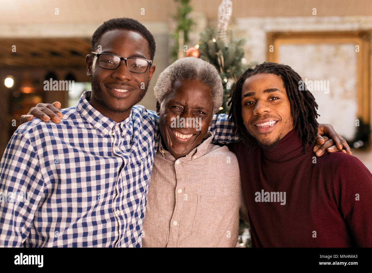 Portrait grandfather and grandsons hugging Stock Photo