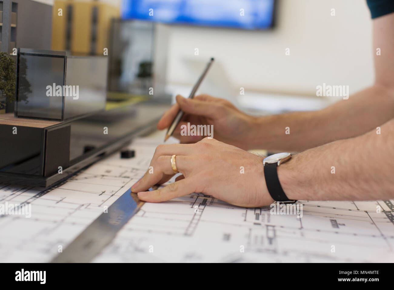 Close up architect drafting blueprint with ruler and pencil Stock Photo