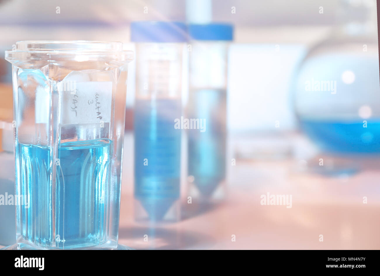 Scientific background. Tools for histopathology, fixative vials for biopsy tissue, rask of slide glasses in staining solution, space for your text. Stock Photo