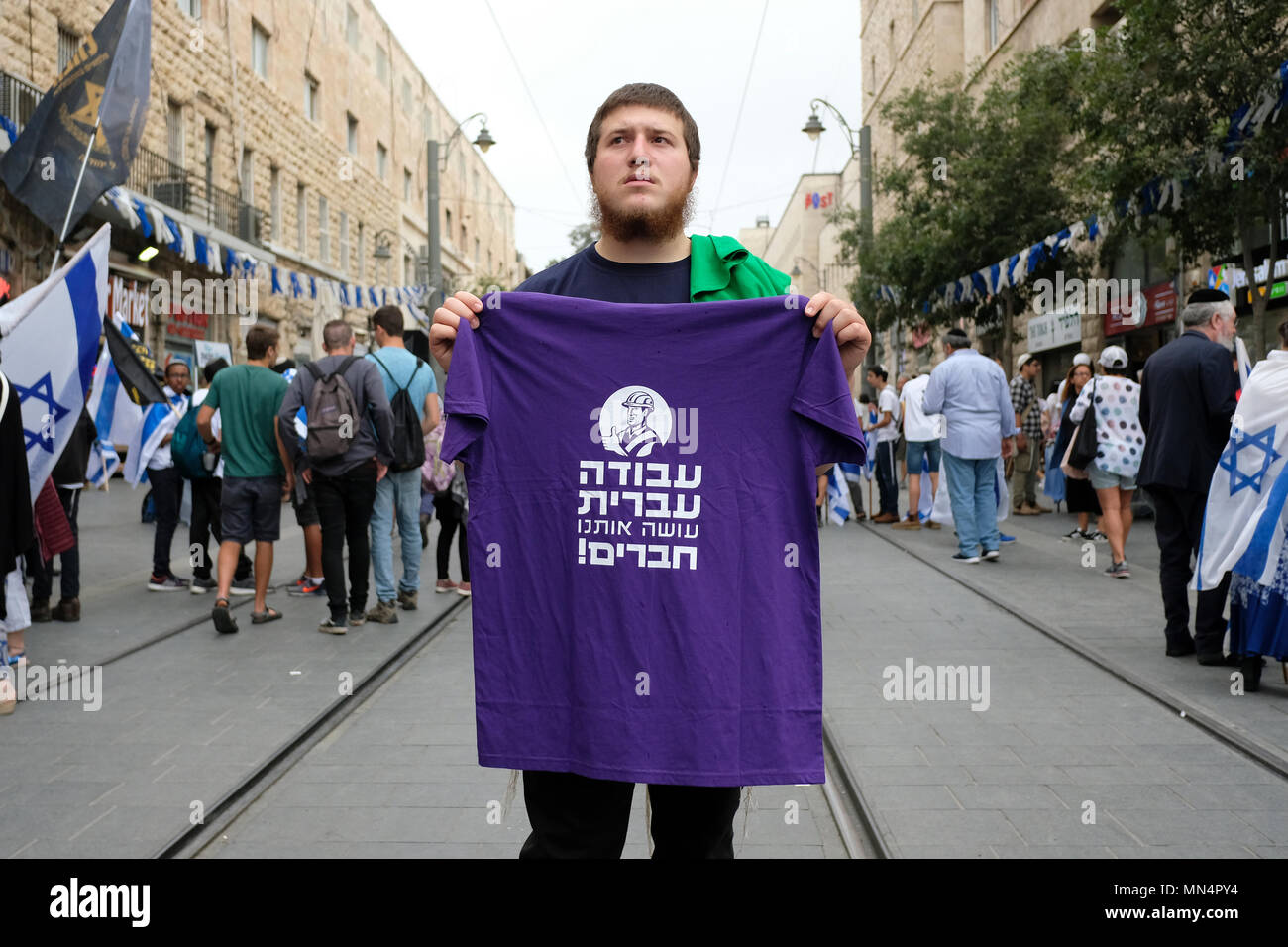 An Israeli right-wing activist holds a T shirt with slogan in Hebrew which reads 'Hebrew work makes us friends' encouraging employers to hire Jewish laborers during 51st anniversary of Jerusalem's reunification on 13th May 2018. Israel Stock Photo