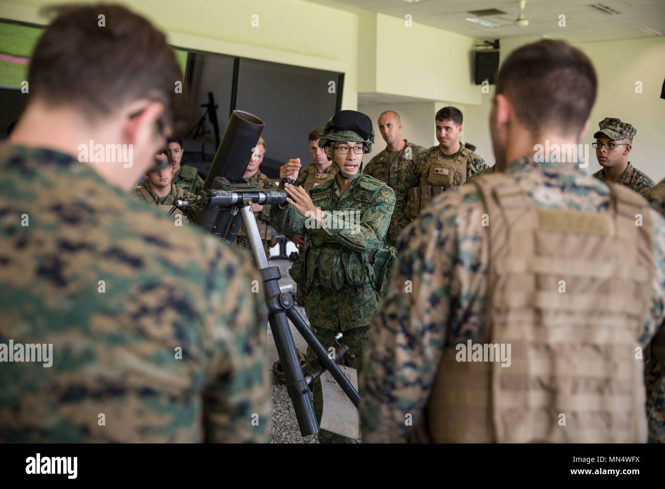 A Singapore Armed Forces soldier teaches U.S. Marines and Sailors about