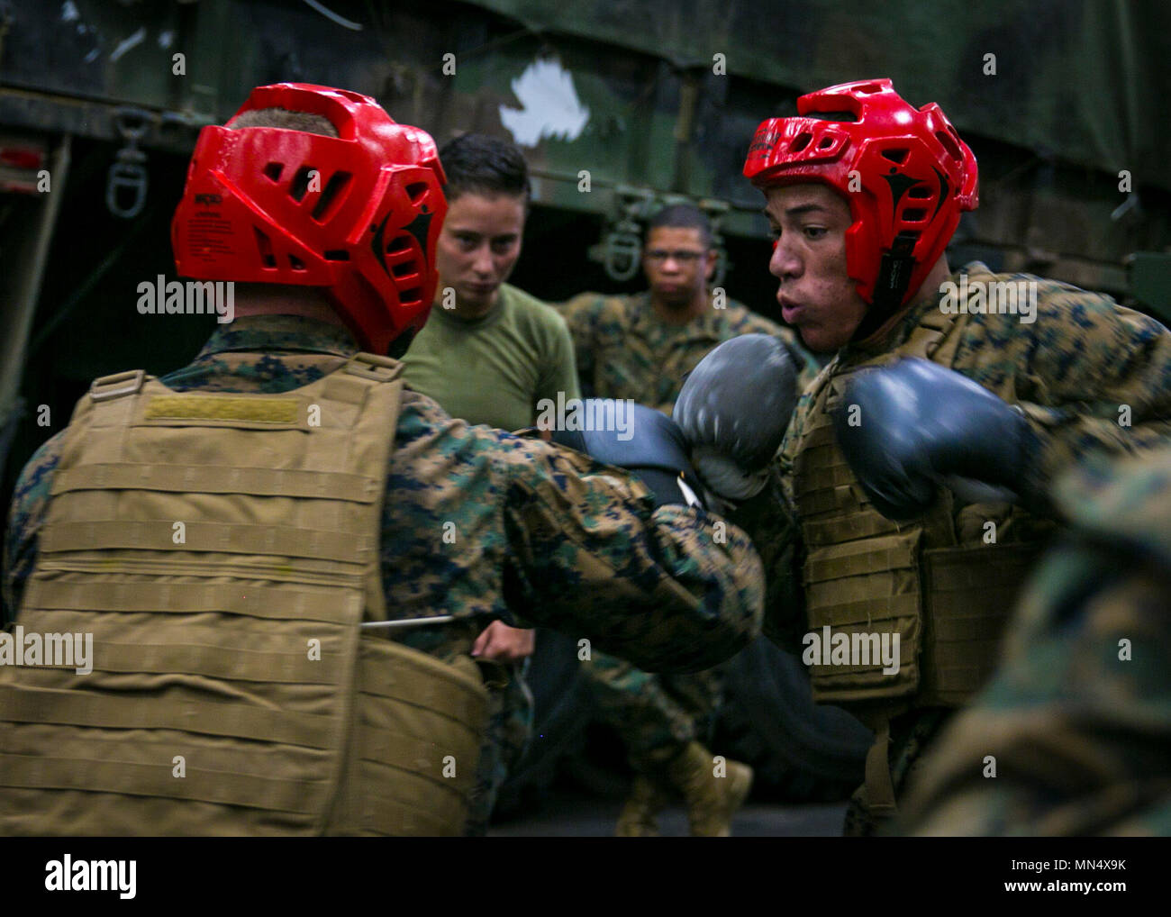 PACIFIC OCEAN – Marines with the 15th Marine Expeditionary Unit’s Logistics Combat Element box as part of their combat conditioning portion during a Marine Corps Martial Arts Program course held aboard USS Pearl Harbor (LSD 52), Aug. 9, 2017. MCMAP teaches Marines self-defense and submission techniques in order to be more effective during hand-to-hand combat. The 15th MEU and America Amphibious Ready Group are operating in the U.S. 7th Fleet area of operations to enhance partnerships and serve as a ready-response capability for any type of contingency.  (U.S. Marine Corps photo by Cpl. F. Cord Stock Photo