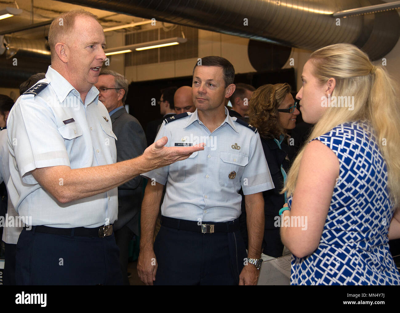 Lt. Gen. Robert McMurry, Air Force Life Cycle Management Center commander, speaks with Courtney Wilson, founder and CEO of DropZone for Veterans, during an event at MassChallenge in Boston Aug. 29, while Col. Bradley W. McDonald, 88th Air Base Wing commander, looks on. During the event, AFMC senior leaders met with key industry and civic leaders in the local area. (U.S. Air Force photo by Mark Herlihy) Stock Photo