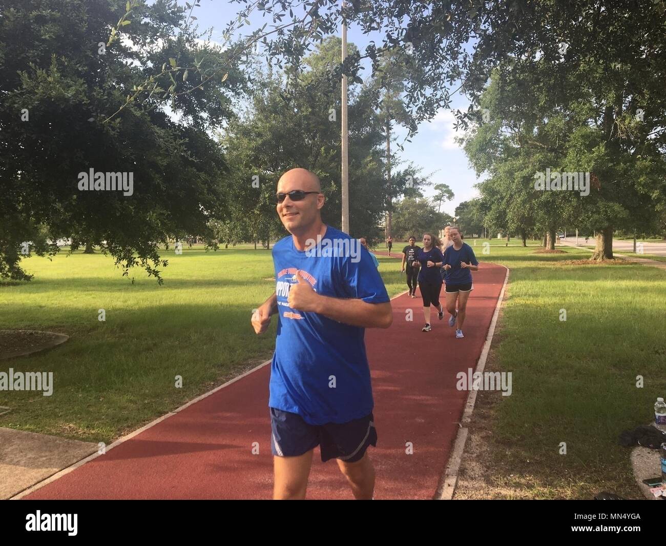 Master Sgt. Travis Rhoades, 403rd Wing recruiter, runs with members of