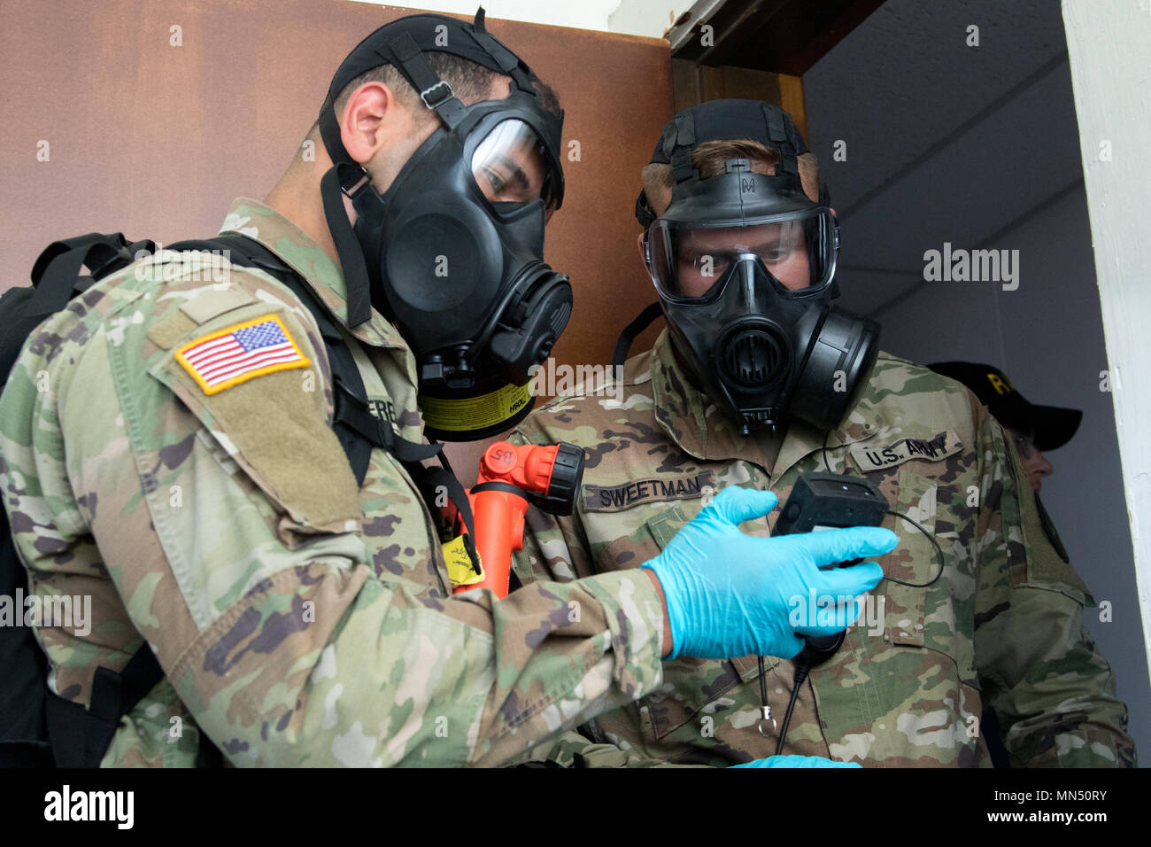 Sgt. Mauricio Caceres, left, communicates to Staff Sgt. Cory Sweetman