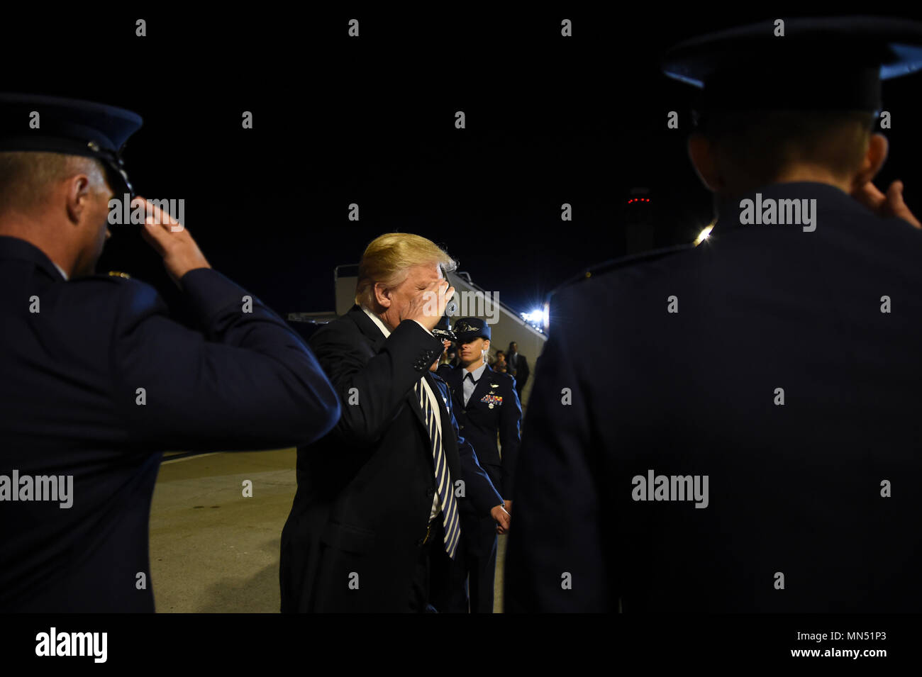 President of the United States Donald J. Trump salutes the official greeting party upon arriving at Joint Base Andrews, Md., May 10, 2018 as he prepares to greet three Americans who were freed from North Korean prison on May 9, 2018. An 89th Airlift Wing C-40 high-priority personnel transport aircraft carried Kim Dong-chul, Tony Kim and Kim Hak-song from North Korea to Anchorage, Alaska where the plane refueled before arriving at JBA at 3 a.m. EST. The 89th AW executes special missions such as these on a routine basis while enabling national interests through global transportation for America' Stock Photo