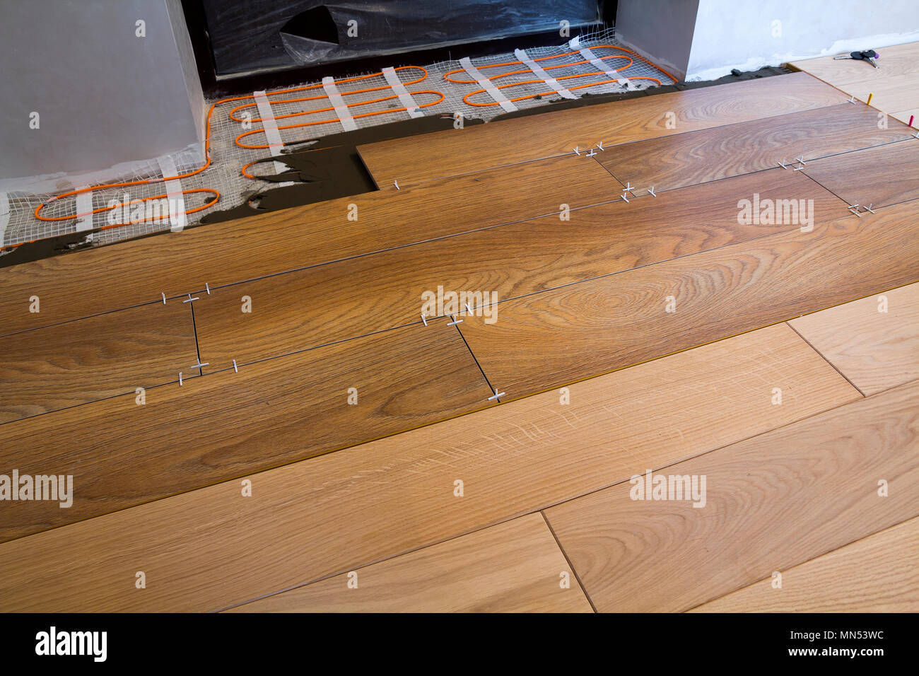 Installation of ceramic tiles and heating elements in warm tile floor