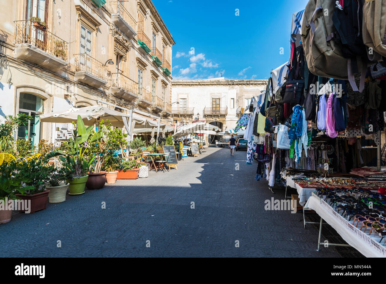 Siracusa, Italy - August 17, 2017: Souvenir shop in a flea market and a terraces of bar restaurant on a street in Siracusa, Sicily, Italy Stock Photo