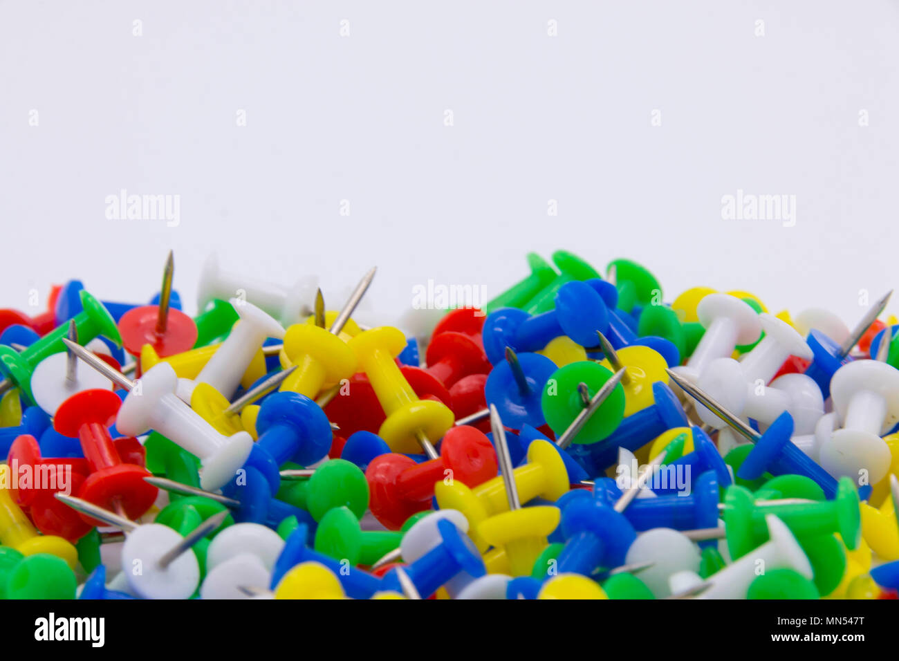 Pile of plastic notice board push pins on a white background Stock