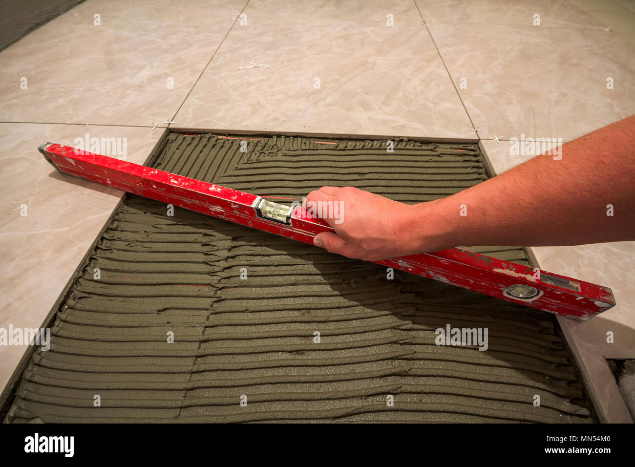 Ceramic Tiles And Tools For Tiler Worker Hand Installing Floor