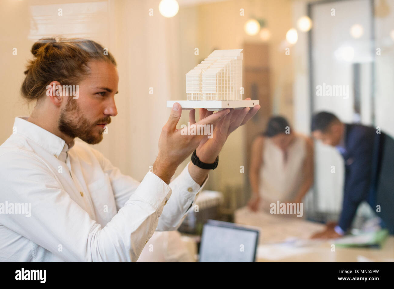 Focused, curious male architect examining model Stock Photo