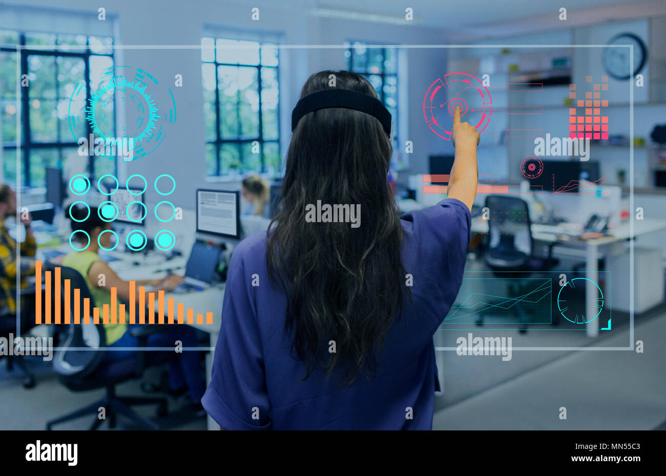 Businesswoman using futuristic hologram computer in office Stock Photo