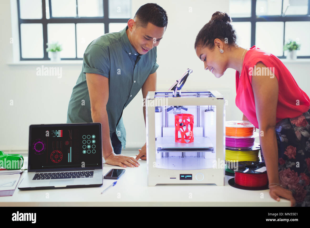 Designers watching 3D printer Stock Photo