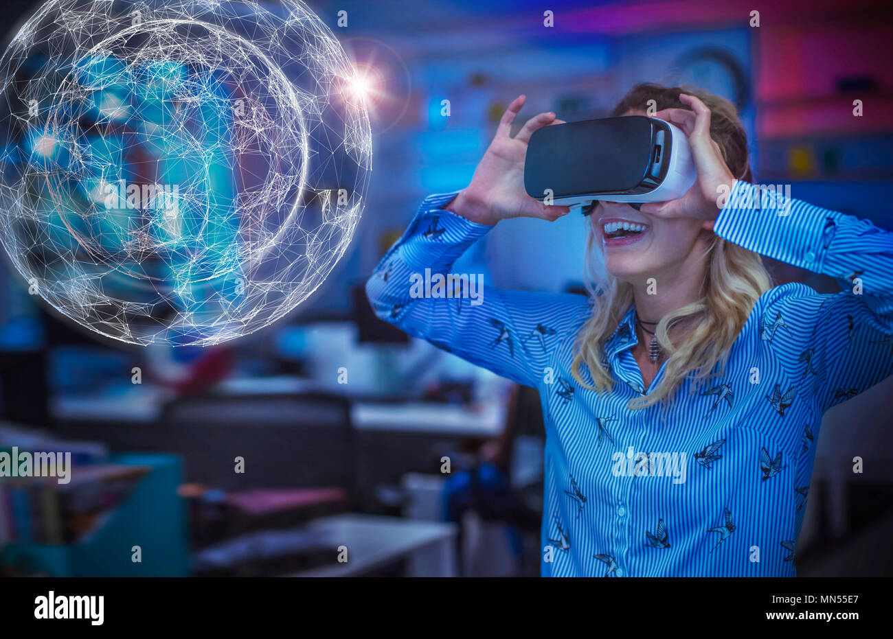Enthusiastic female computer programmer testing virtual reality simulator glasses, viewing futuristic hologram Stock Photo