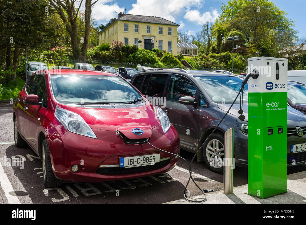 Electric car charging in a car park in Skibbereen, County Cork, Ireland. Stock Photo